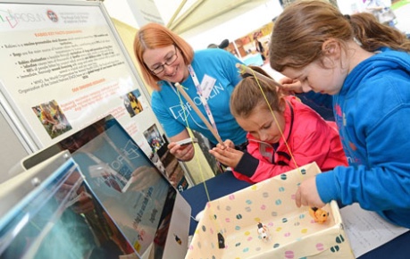 photo of young people taking part in an activity session about rabies research hosted by Easter Bush Campus at the Royal Highland Show