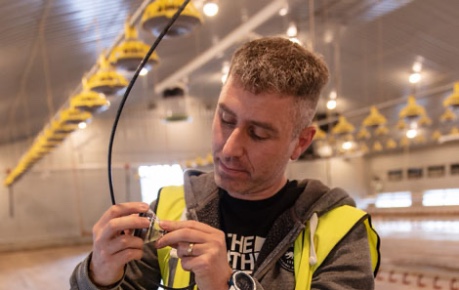 Greengage Agritech COO checking sensor in shed - photo shared by Courteenhall